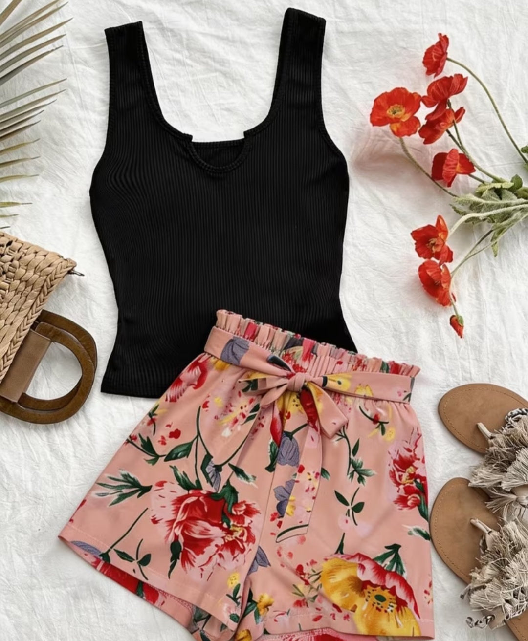 Floral shorts and black ribbed vest top co-ord set laid flat