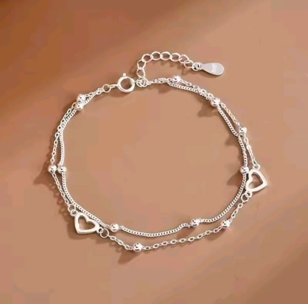 Double layer silver heart charm bracelet with ball bead detailing